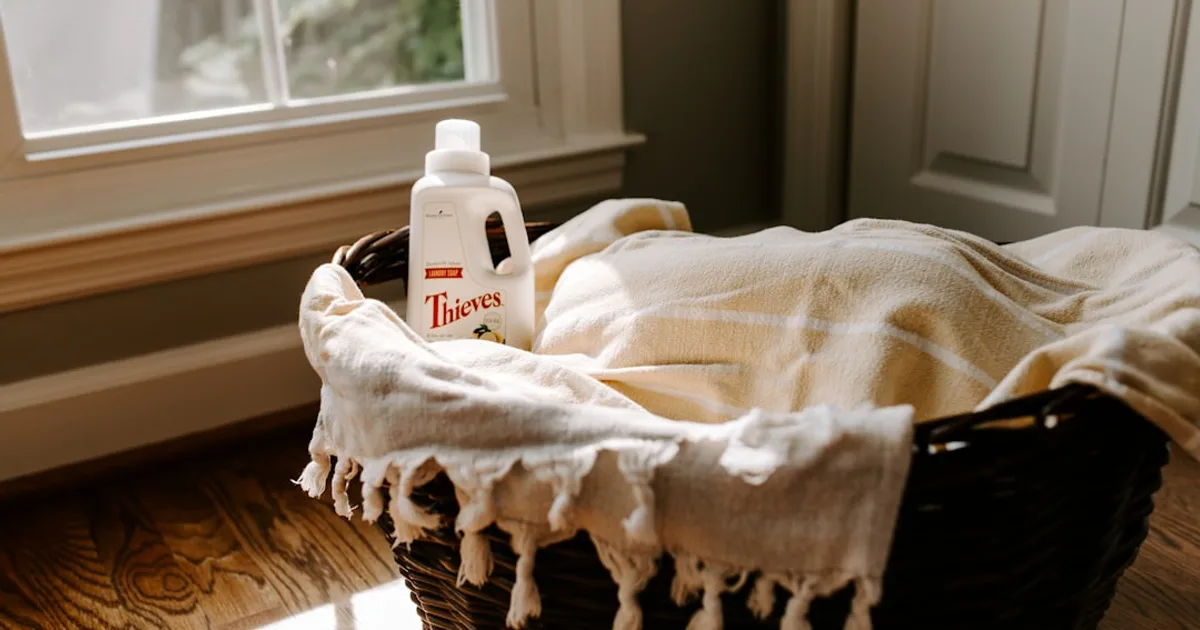 a bottle of deodorant sitting on top of a blanket