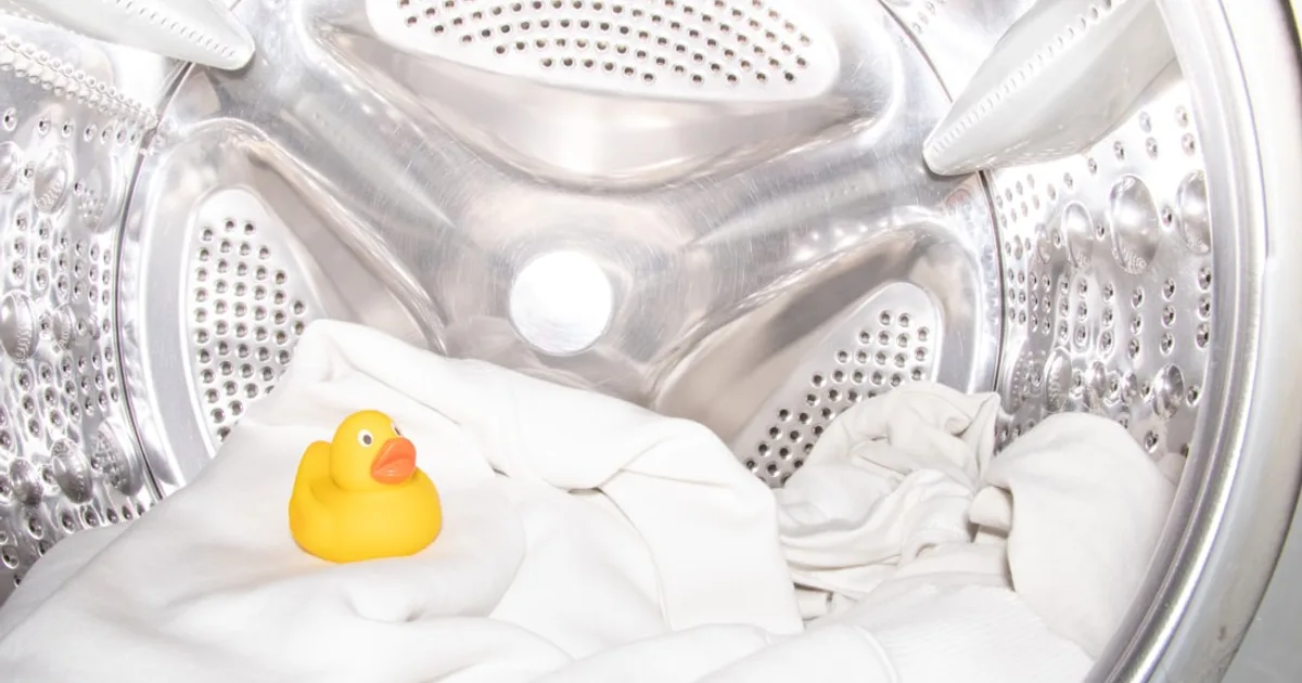 a rubber ducky toy sitting inside of a washing machine